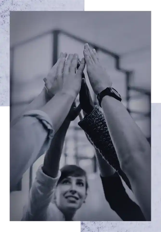 Team joining hands in celebration, representing collaboration and success in software consultancy.